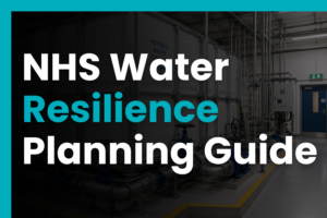 GRP potable water storage tank with pipework and blue valves in a clean NHS plant room, representing water resilience planning for healthcare facilities.